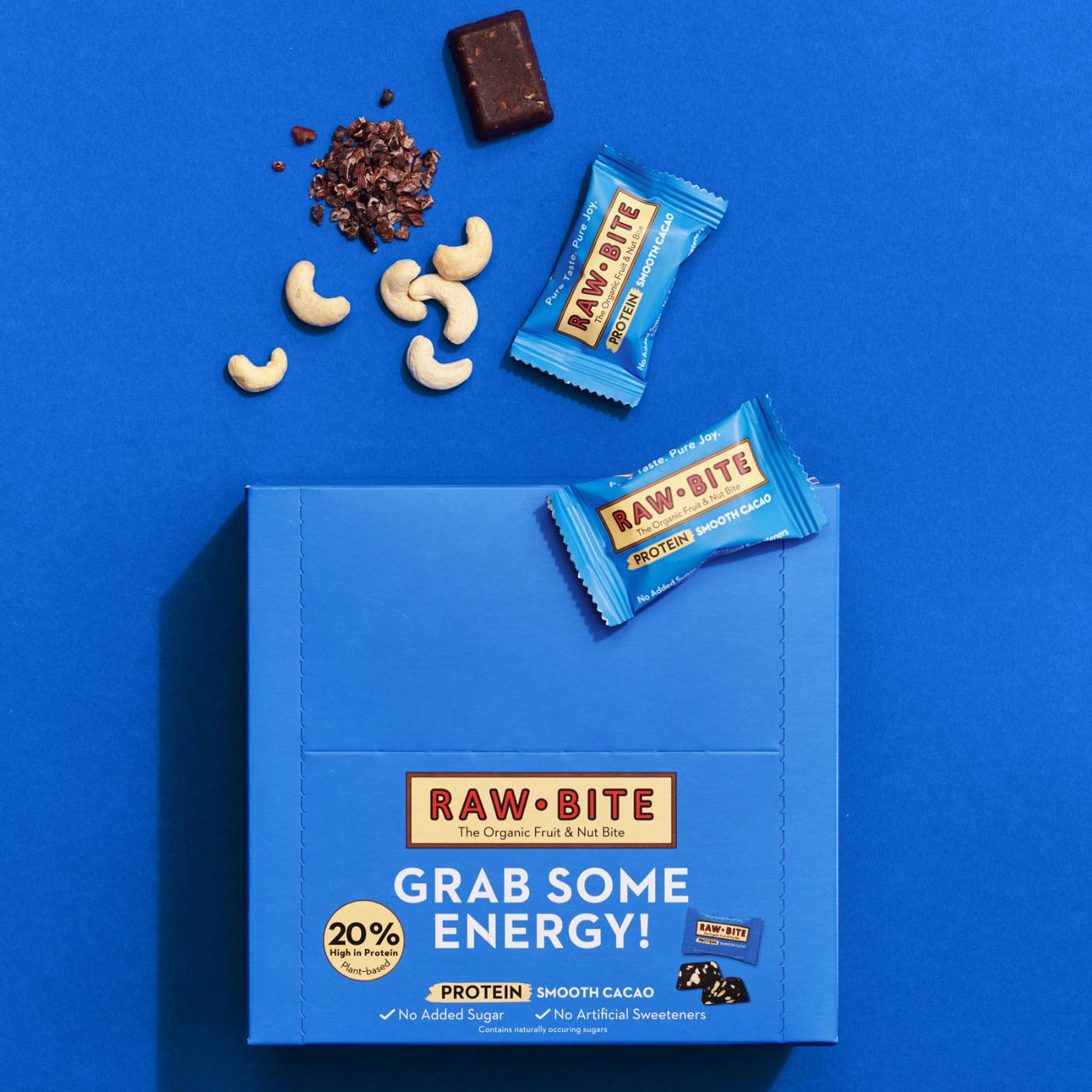 RAWBITE protein bars and packaging on a blue background